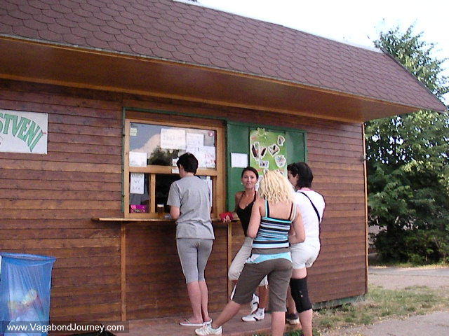 Czech girls in tight pants waiting for beer at a kiosk in a park