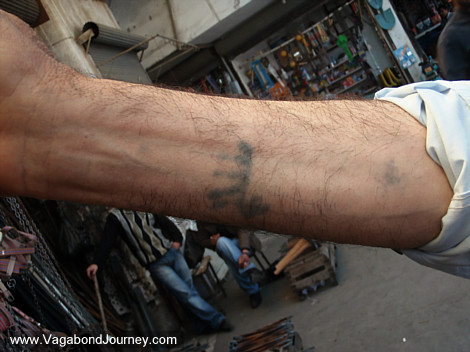 This man has traditional Muslim tattoos over his hands, lower arms, temples,