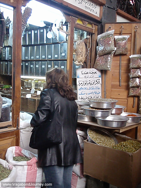 woman buy herbs in market damascus, syria