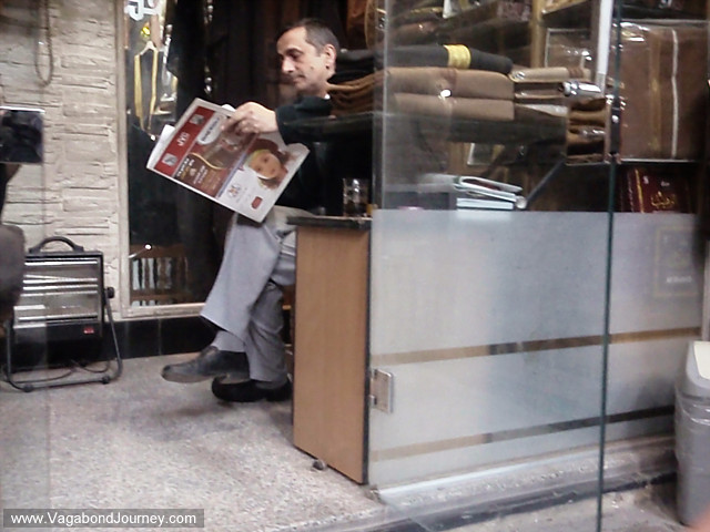 man reading newspaper in damascus