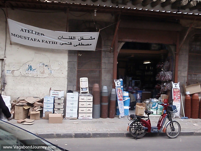 motorbike in front of arabic sign
