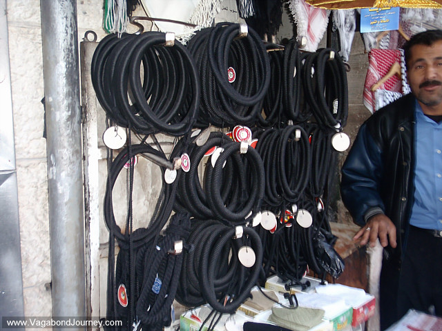 street stall owner selling arabic headscarves in amman